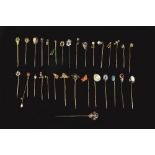 A COLLECTION OF STICK PINS, to include a coral corallium rubrum stick pin, carved to depict a boar's