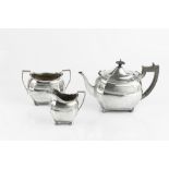 AN EDWARDIAN SILVER THREE PIECE TEA SERVICE, with gadrooned borders, the shaped bodies with a band