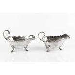 A PAIR OF 18TH CENTURY FRENCH SILVER SAUCE BOATS, with shaped borders, scroll handles and stepped
