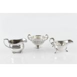 A SILVER MILK JUG, with gadrooned border, on ball feet, by Goldsmiths & Silversmiths Co. Ltd, London