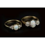 TWO OPAL AND DIAMOND DRESS RINGS, the first centred with an oval cabochon opal in claw setting,