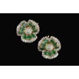 A PAIR OF EMERALD AND DIAMOND FLOWERHEAD EAR CLIPS, each shaped flowerhead panel centred with a pavé