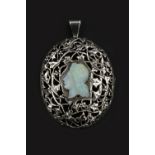 AN OPAL CAMEO PENDANT/BROOCH, the oval panel pierced and engraved with ivy leaves and berry