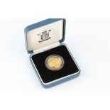A REPUBLIC OF SOMALIA 9CT GOLD 1000 SCHILLINGS COIN, dated 2001, cased by The Royal Mint