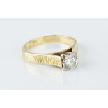 A DIAMOND SINGLE STONE RING, the round brilliant-cut diamond in raised claw setting, between