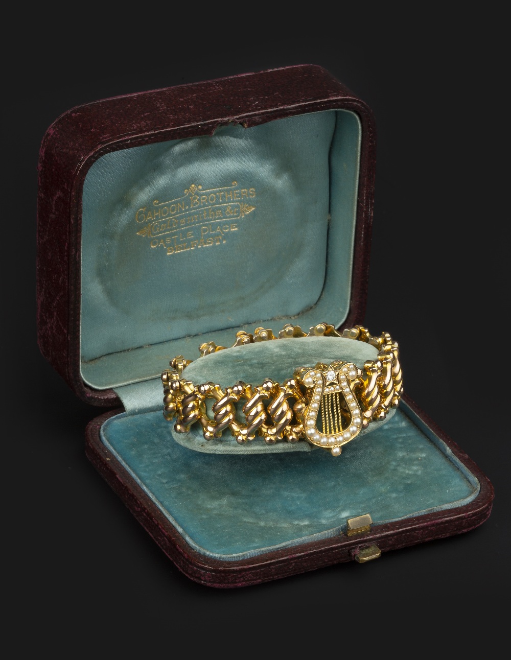 A LATE VICTORIAN HALF PEARL AND DIAMOND SET PANEL BRACELET, the articulated expanding bracelet of