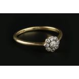 A DIAMOND CLUSTER RING, the flowerhead cluster of old-cut diamonds in millegrain collet setting, two