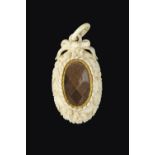 A 19TH CENTURY IVORY AND HAIRWORK MEMORIAL PENDANT, the ivory mount carved with flowerheads and