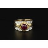 A RUBY AND DIAMOND DRESS RING, the tapered band centred with a circular cabochon ruby in lozenge-