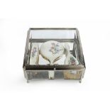 A SILVER PLATED SQUARE SECTION DISPLAY CASE, with bevelled glass top and sides, and mirrored base,