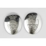 A PAIR OF GEORGE III SILVER OVAL SHOULDER BELT PLATES, each engraved with a crowned coat of arms, by