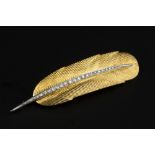 A DIAMOND SET FEATHER BROOCH, centred with a channel of graduated single-cut diamonds, two colour