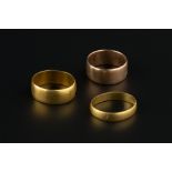 TWO 22CT GOLD WEDDING BANDS, and a 9ct gold wedding band (3)