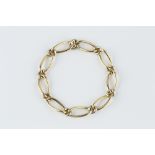 AN 18CT TWO COLOUR GOLD BRACELET BY CARTIER, of fancy curb-link design, signed Cartier Paris and