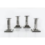 A PAIR OF LATE VICTORIAN SILVER DWARF CANDLESTICKS, with fluted columns, beaded drip pans and beaded