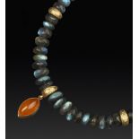 A LABRADORITE AND GARNET PENDANT NECKLACE ATTRIBUTED TO FIONA RAE, comprising a single strand of