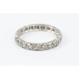 A DIAMOND FULL HOOP ETERNITY RING, grain set throughout with single-cut diamonds, white precious