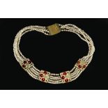 AN INDIAN COLLAR NECKLACE, designed as four rectangular panels, each inset with a cluster of