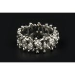 A DIAMOND SET DRESS RING, the openwork abstract band highlighted with graduated round brilliant-