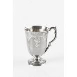 A MID VICTORIAN SILVER CHRISTENING CUP, engraved with strapwork, and with shaped handle, on pedestal