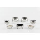 A SET OF FOUR MID VICTORIAN SILVER CIRCULAR SALTS, with gadrooned borders, on shaped feet, by George