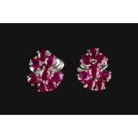 A PAIR OF RUBY CLUSTER EAR STUDS, each designed as a ribbon-shaped cluster of oval mixed-cut