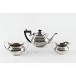 A SILVER THREE PIECE BACHELOR'S TEA SERVICE, the teapot with ebonised handle and knop, by Charles S.