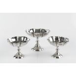 A SET OF THREE EDWARDIAN SILVER SWEETMEAT DISHES, comprising one large and two smaller, of lobed