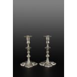 A PAIR OF GEORGE II SCOTTISH SILVER CANDLESTICKS, with knopped stems, on shaped square bases with