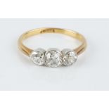 A DIAMOND THREE STONE RING, the graduated old-cut diamonds in collet setting, two colour precious