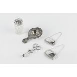 A CONTINENTAL SILVER TEA STRAINER, the borders cast with cherubs and flowers, import marks for