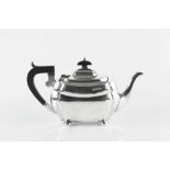 A SILVER TEAPOT, of shaped outline, with ebonised handle and knop, on bun feet, by S Blanckensee &