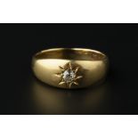 AN EDWARDIAN DIAMOND SINGLE STONE GYPSY RING, the old-cut diamond in star-shaped setting, to a