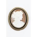 A VICTORIAN SHELL CAMEO BROOCH, the oval shell cameo carved to depict a bacchante, to a bead and