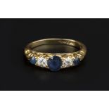A SAPPHIRE AND DIAMOND FIVE STONE RING, the scroll pierced hoop alternately set with oval and