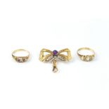 AN AMETHYST AND DIAMOND SET BOW BROOCH, the foliate engraved ribbon bow centred with a circular