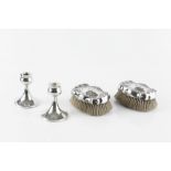 A PAIR OF EARLY 20TH CENTURY AMERICAN SILVER BACKED CLOTHES BRUSHES, of shaped outline, chased and