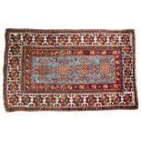 A KASAK RUG, the central mid blue ground panel with four hooked medallions within a polychrome