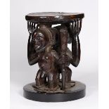 A LUBA-HEMBA STOOL, Democratic Republic of the Congo, carved wood Janiform, one figure with