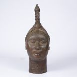 A BENIN BRONZE HEAD, of a female with high pointed hair style, the face covered with incised