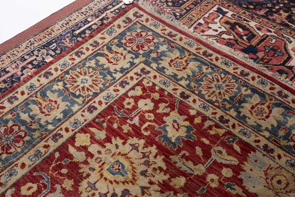 AN AGRA RED GROUND CARPET the repeating foliate and scroll motif within a dark blue ground border, - Image 3 of 5