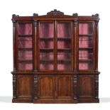 A WILLIAM IV MAHOGANY BREAK FRONT LIBRARY BOOKCASE, the top sections with scrolled crestings over