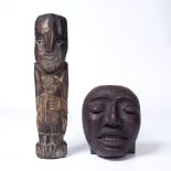 A NAIVE CARVED WOOD FIGURE, holding a child, 35cm high, together with a lacquered face mask (2)