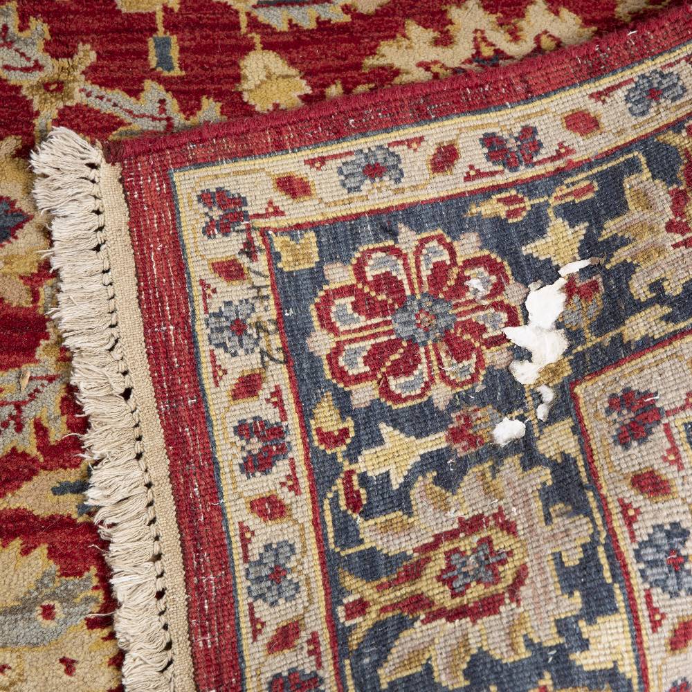 AN AGRA RED GROUND CARPET the repeating foliate and scroll motif within a dark blue ground border, - Image 5 of 5
