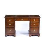 A GEORGIAN STYLE MAHOGANY PEDESTAL DESK, the top with gilt tooled Morocco leather inset above one