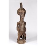 A SONGYE POWER FIGURE, Democratic Republic of the Congo carved wood 'NKISHI', standing on a circular