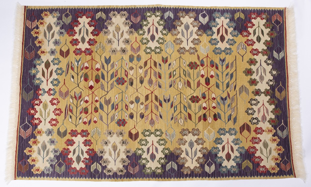 A TURKISH MULTICOLOURED KELIM with a continuing pattern of rosettes and arrows on a pale ochre - Image 2 of 2