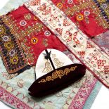 A GROUP OF INDIAN DECORATIVE TEXTILES including a Kashmiri shawl, a felt hat, a table cover and a