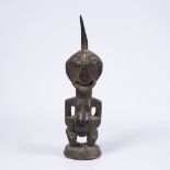 A SONGYE POWER FIGURE, carved wood, horn inserted into the top of the forehead 57cm high