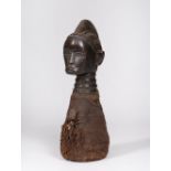 A WEST AFRICAN KISSI POWER FIGURE, carved wood with a coiffure, ribbed neck and decorated with cloth